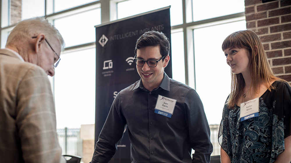 entrepreneurs networking at a presentation booth
