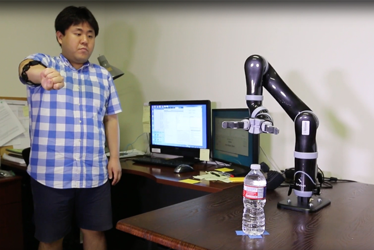 Sungtae Shin Interacting With His Robotic Arm Design