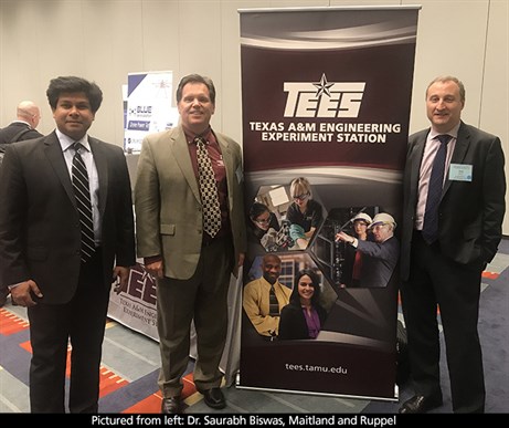 Photo of Dr. Saurabh Biswas, Maitland, and Ruppel posing in front of TEES Texas A&amp;M Engineering Experiment Station banner