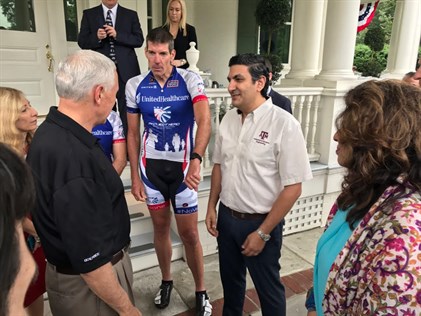 Dr. Farzan Sasangohar talking to US Vice President Mike Pence and others gathering around a porch.