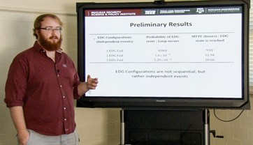 Image of Oneal giving a presentation with a slide showing Preliminary Results