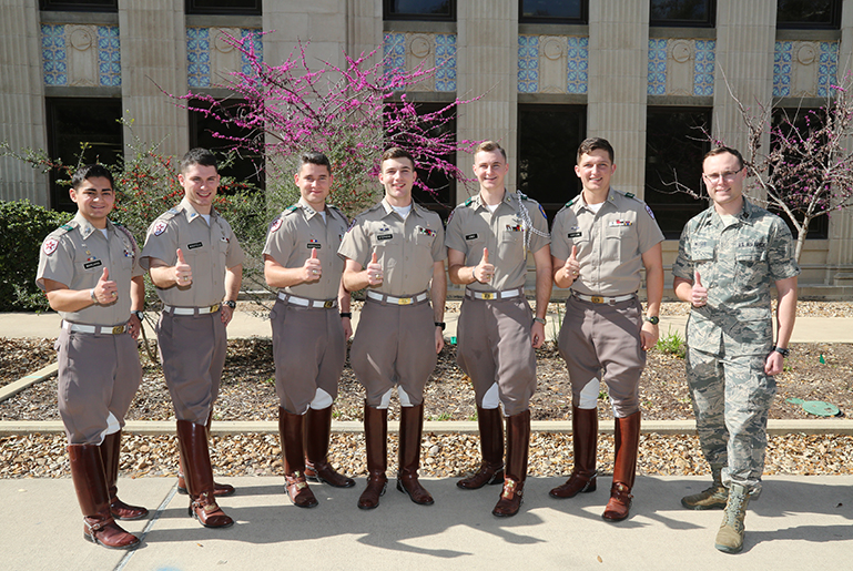 Aerospace students in the US Air Force uniform giving thumbs up.