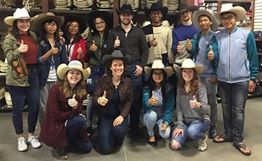 Group of students tried on some cowboy hats in Austin