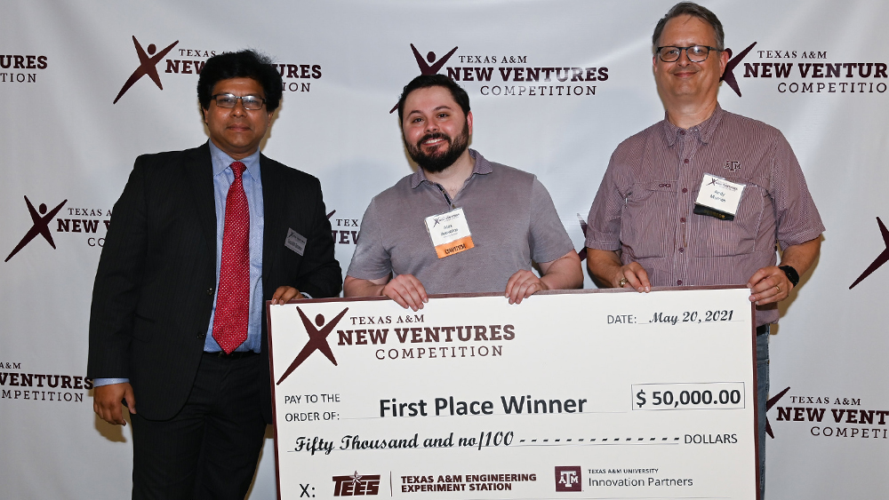 Three men posing with a giant check for Starling Medical, the first place winners for the Texas A&M New Ventures Competition