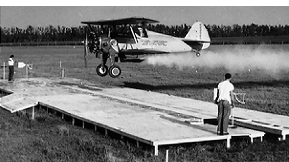 Duster airplane on crop field in 1949.