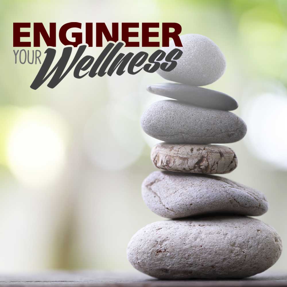 Engineer Your Wellness in the foreground with three stones stacked on top of one another in the background