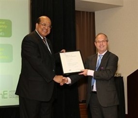 Photo of Dr. Mannan, another individual, and a certificate