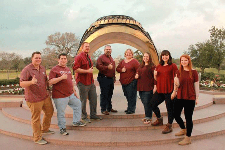 Dean and Glenda Schneider With Their Six Children In Front of The Aggie Ring in the Association of Former Students