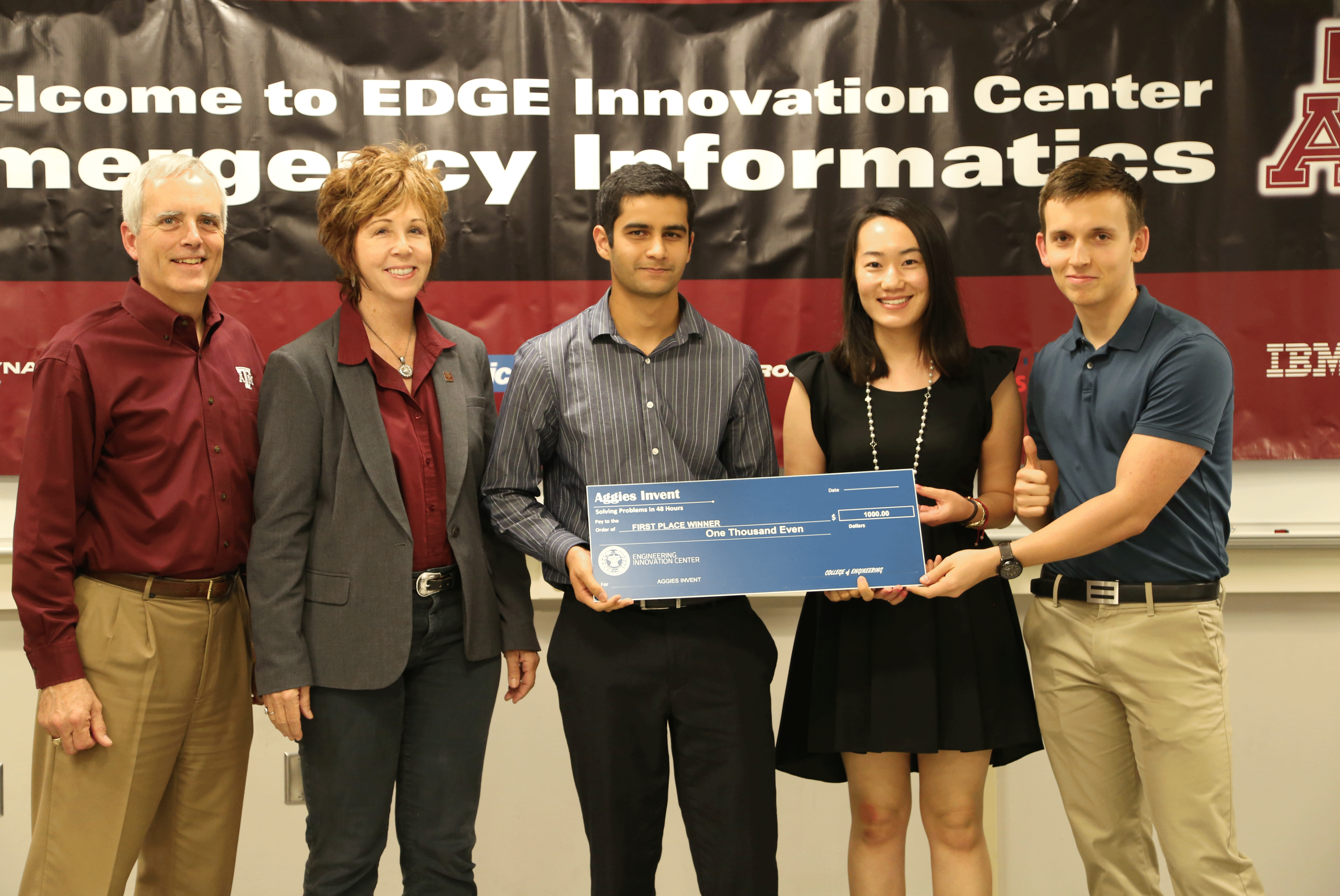 Grace Duoduo, Mack Ragland and Milan Pandya Being Awarded A Check Of One Thousand Dollars From Aggie Invent