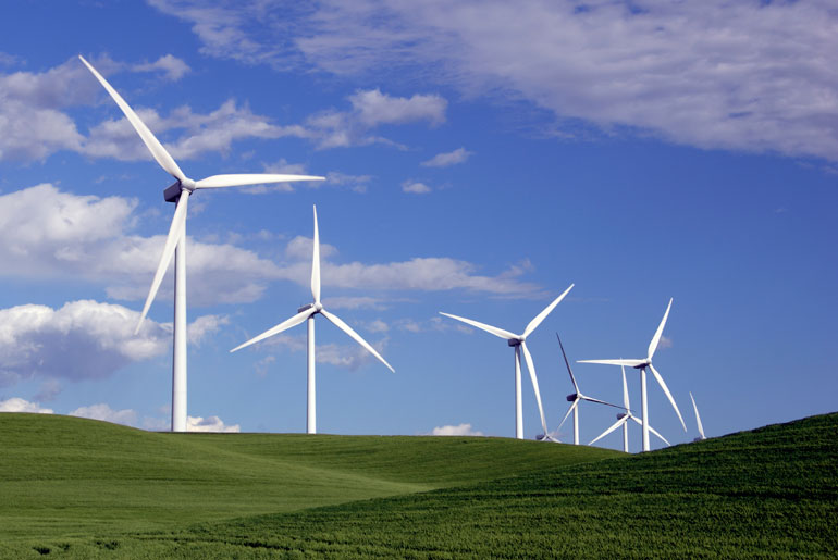 Wind Turbines On A Grassy Field