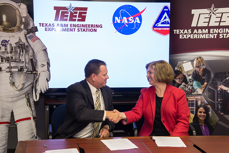 Katherine Banks Shaking Hands With A NASA/JSC Representative