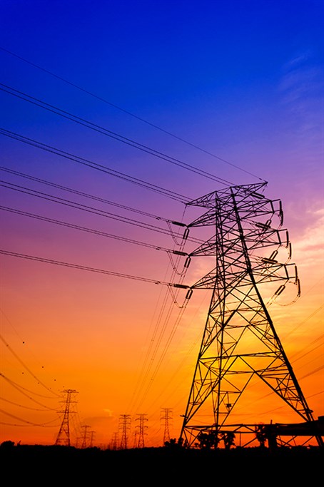 Image of power lines with a sunset background