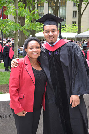 Dr. Cortlan Wickliff posing with his mom during graduation from Harvard.