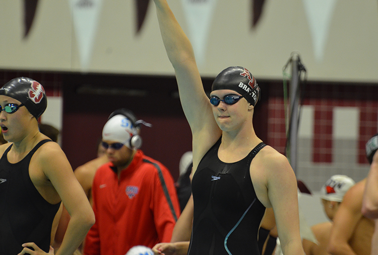 Lisa Bratton in swim wear raising an arm.