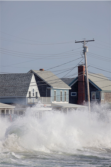 Waves of water hitting houses.