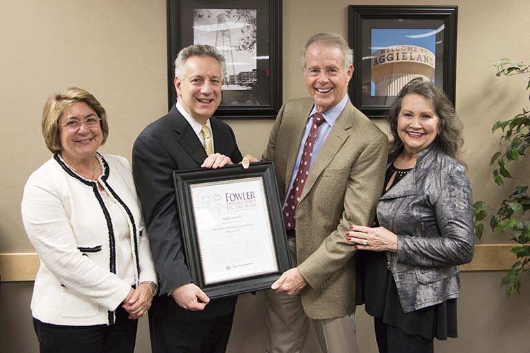 Group photo with Dr. Dennis Assanis and three others holding The Fowler distinguished lecture series certificate.