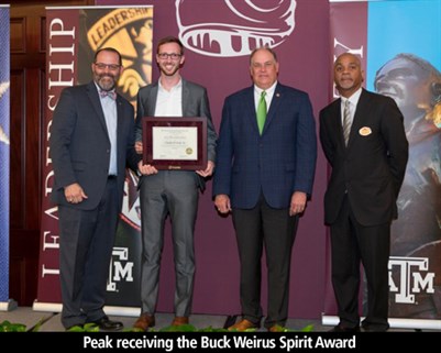 Peak receiving the Buck Weirus Spirit Award