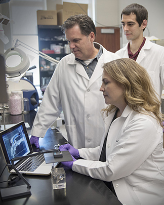 Dr. Ashley Saunders, Dr. Duncan Maitland and Dr. Mark Wierzbicki working in the lab