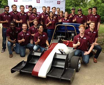 Texas A&amp;M Formula SAE Racing team in front of their race car