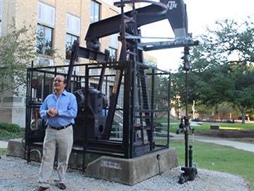 Dr. Ibere Alves by the oil pump in TAMU campus