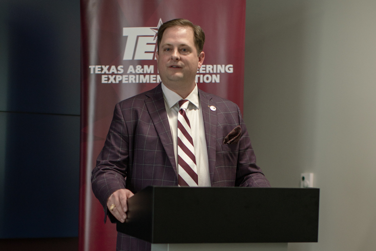 Rob Gorham, standing on the podium with Texas A&amp;M Engineering Experiment Station (TEES) banner in the background.