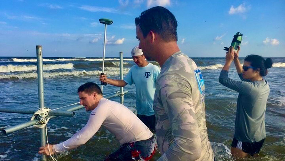 Dr. Jens Figlus and his students setting up research equipment in the Galveston shore