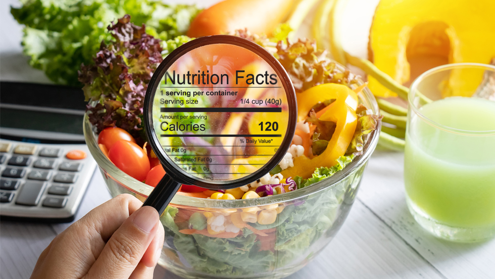 A table of food and over it is a magnifying glass showing nutrition facts.