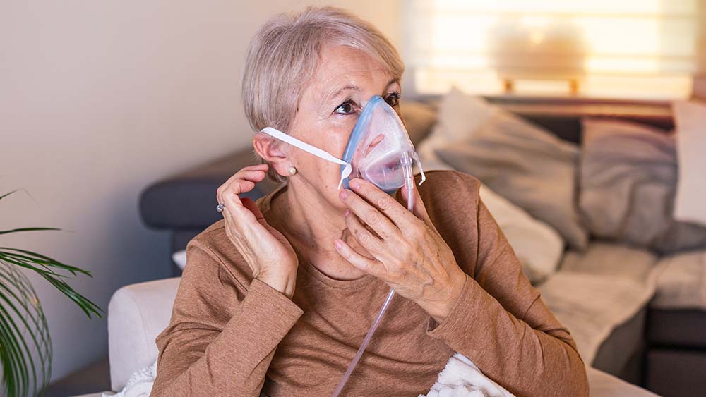 Older woman wearing an oxygen mask.