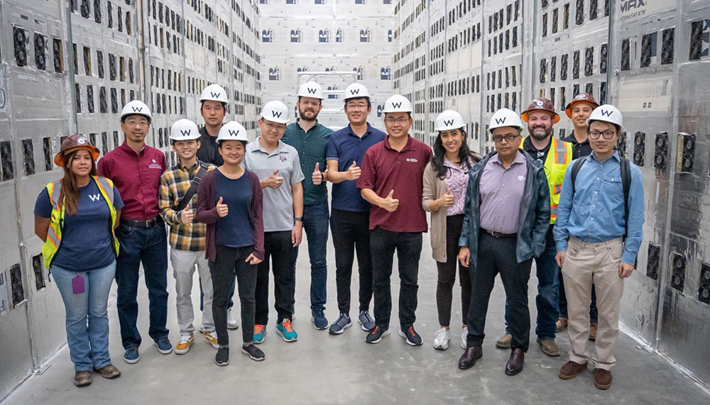 The Texas A&M Blockchain and Energy Research Consortium team standing in Riot’s Rockdale Facility.