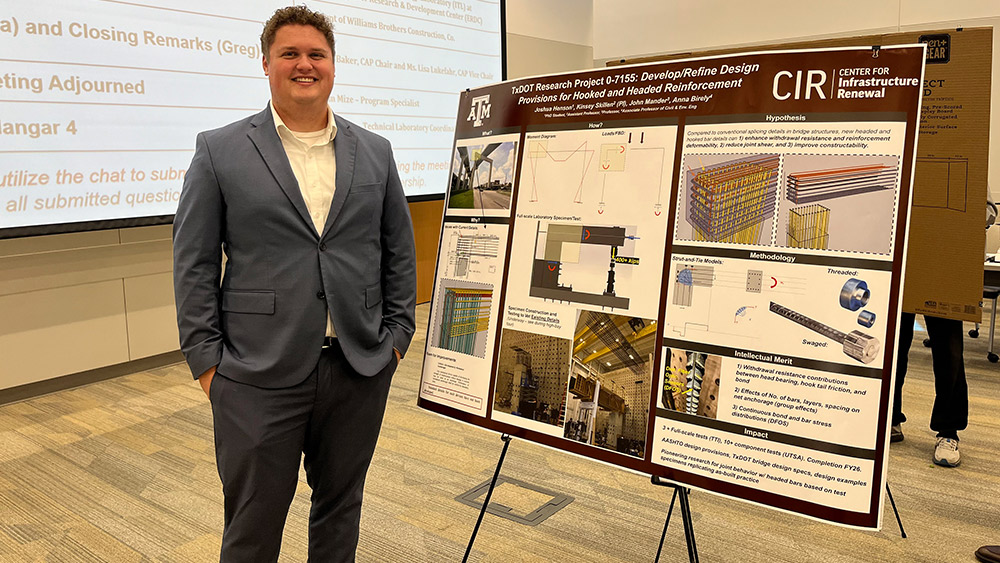 Joshua Henson standing in front of a poster