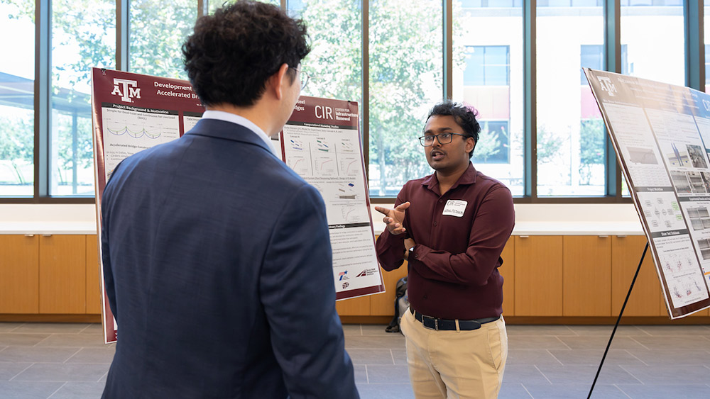 Nikhil Potnuru standing in front of a poster