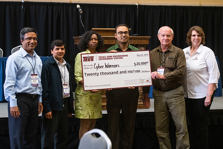 Winning team, the Cyber Warriors, being presented with a $20,000 check.