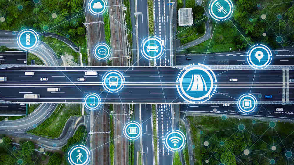 Aerial view of train trucks, highways and roads overlaid with icons of vehicles and road.